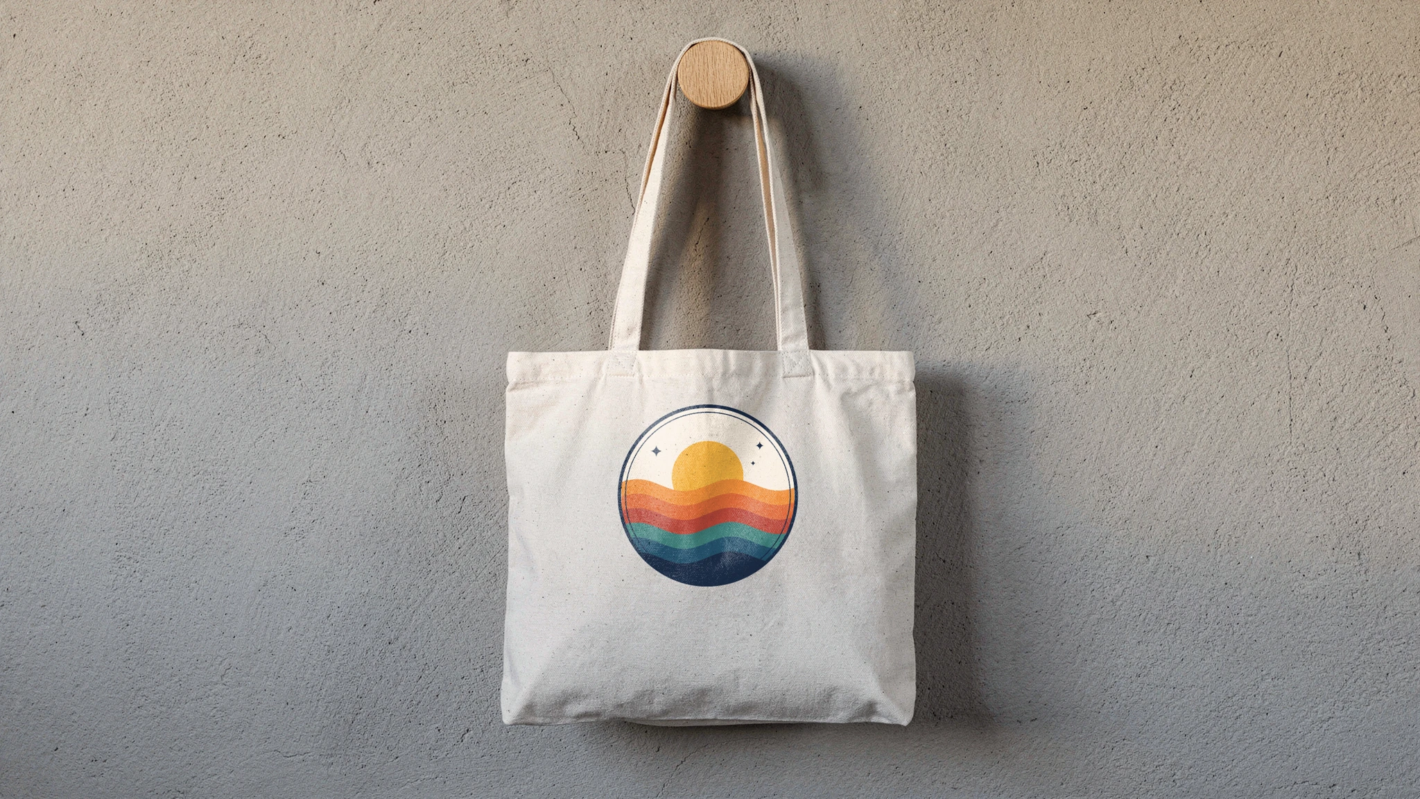 Canvas tote mockup rendered from a product photo with a round sunset and waves badge on the front panel