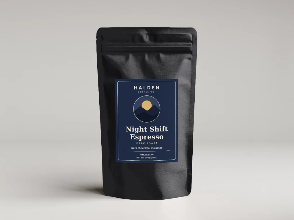 A black stand-up coffee pouch with a navy Night Shift Espresso dark roast label, the bag recolored and the label placed in one API request